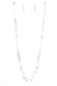 Varying in shape and shimmer, faceted white and metallic crystal-like beads trickle down the chest for a whimsical look. Features an adjustable clasp closure.  Sold as one individual necklace. Includes one pair of matching earrings.