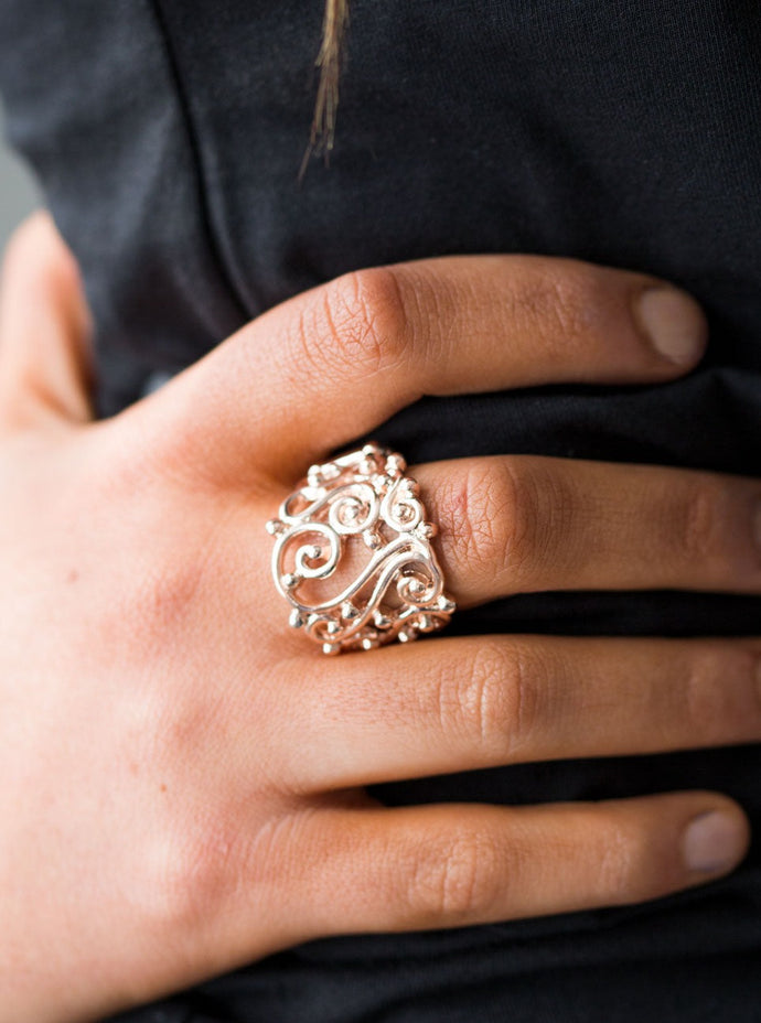 Glistening rose gold bars swirl across the finger, creating airy filigree. Shiny rose gold studs are sprinkled across the frilly pattern, adding tactile shimmer to the regal pattern. Features a stretchy band for a flexible fit.   Sold as one individual ring. 