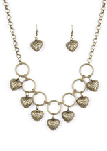 Load image into Gallery viewer, Stamped in whimsical patterns, vintage inspired hearts cascade from the bottom of airy brass hoops, creating a romantic fringe below the collar. Features an adjustable clasp closure.  Sold as one individual necklace. Includes one pair of matching earrings.