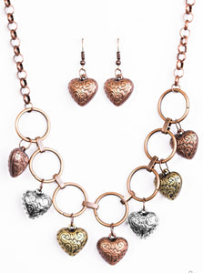 Stamped in whimsical patterns, vintage inspired brass, copper and silver hearts cascade from the bottom of airy copper hoops, creating a romantic fringe below the collar. Features an adjustable clasp closure.  Sold as one individual necklace. Includes one pair of matching earrings.