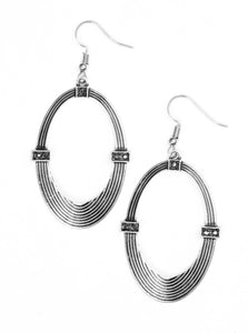 Etched in circular textures, a shimmery silver oval is encrusted in dainty hematite frames for an edgy look. Earring attaches to a standard fishhook fitting.  Sold as one pair of earrings.