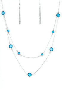 Varying in size, glassy blue gems trickle along dainty silver chains, creating sparkling layers across the chest. Features an adjustable clasp closure.  Sold as one individual necklace. Includes one pair of matching earrings.