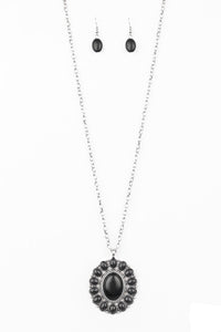 Radiating with black stone accents, a dramatic floral pendant swings from the bottom of a lengthened silver chain for a seasonal look. Features an adjustable clasp closure.  Sold as one individual necklace. Includes one pair of matching earrings.