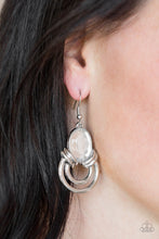 Load image into Gallery viewer, Shimmery silver hoops radiate from the bottom of a dramatic white gem fitting, coalescing into a regal frame. Earring attaches to a standard fishhook fitting.  Sold as one pair of earrings.  Always nickel and lead free.