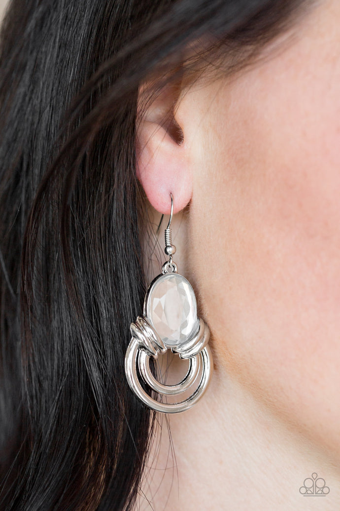Shimmery silver hoops radiate from the bottom of a dramatic white gem fitting, coalescing into a regal frame. Earring attaches to a standard fishhook fitting.  Sold as one pair of earrings.  Always nickel and lead free.