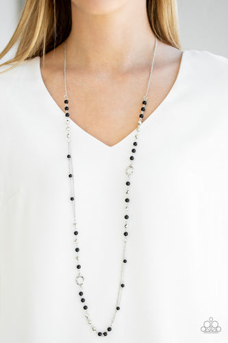   A collection of shiny black beads, twisting silver hoops, and faceted silver beads trickle along an asymmetrical silver chain for a refined look. Features an adjustable clasp closure.  Sold as one individual necklace. Includes one pair of matching earrings. Always nickel and lead free.