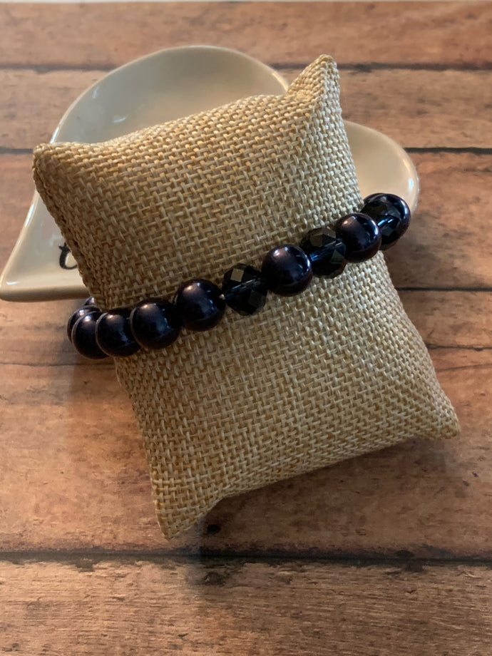 Infused with three metallic crystal-like beads, a refined collection of blue pearls is threaded along a stretchy band around the wrist in a timeless fashion.  Sold as one individual bracelet.  Always nickel and lead free.  Fashion Fix Exclusive!
