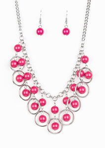 Polished pink beads and shimmery silver hoops drip from the bottom of a glistening silver chain, creating a playful fringe below the collar. Features an adjustable clasp closure.  Sold as one individual necklace. Includes one pair of matching earrings.