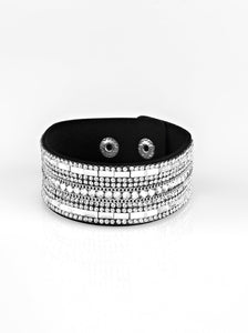  Featuring classic round and edgy emerald style cuts, glittery white rhinestones and glistening silver chains are encrusted along bands of black suede for a sassy look. Features an adjustable snap closure.  Sold as one individual bracelet.