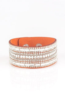 Featuring classic round and edgy emerald style cuts, glittery white rhinestones and glistening silver chains are encrusted along bands of orange suede for a sassy look. Features an adjustable snap closure.  Sold as one individual bracelet. 