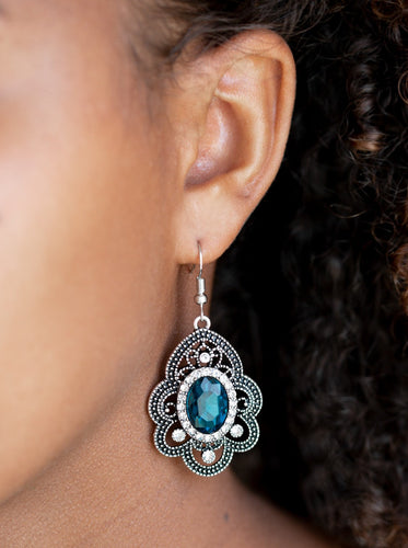 Radiating with studded detail, antiqued silver petals flare from a white and blue rhinestone encrusted center for a regal look. Earring attaches to a standard fishhook fitting.  Sold as one pair of earrings.  