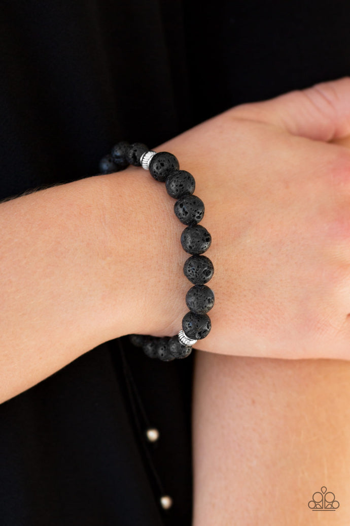 Essential Oil Alert!!  A collection of black lava rock and silver accents are threaded along the wrist for a seasonal look. Features an adjustable sliding knot closure.  Sold as one individual bracelet.  Always nickel and lead free.