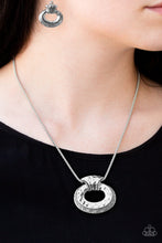 Load image into Gallery viewer, Delicately hammered in shimmery detail, an abstract silver frame slides along a silver popcorn chain below the collar for a bold industrial look. Features an adjustable clasp closure  Sold as one individual necklace. Includes one pair of matching earrings.  Always nickel and lead free.