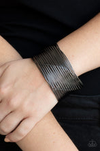 Load image into Gallery viewer, A glistening gunmetal wire weaves through stacked gunmetal bars arcing across the wrist, coalescing into an edgy cuff.  Sold as one individual bracelet.  Always nickel and lead free.