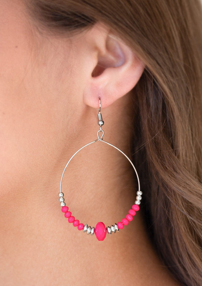 Dainty pink and silver beads slide along the bottom of a silver wire hoop for a seasonal flair. Earring attaches to a standard fishhook fitting.  Sold as one pair of earrings.