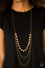 Load image into Gallery viewer, A strand of pearls gives way to shimmery brass chains, creating refined layers down the chest for a glamorous look. Features an adjustable clasp closure.  Sold as one individual necklace. Includes one pair of matching earrings.  Always nickel and lead free.