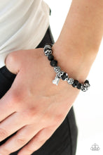 Load image into Gallery viewer, A collection of black crystal-like beads and ornate silver beads are threaded along a stretchy band around the wrist. An abstract silver heart charm swings from the center, for a romantic finish.  Sold as one individual bracelet. Always nickel and lead free.