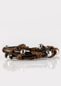 Shiny brown cording knots classic silver beads in place along two brown leather bands for an urban look. Features an adjustable sliding knot closure.  Sold as one individual bracelet.