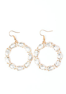 Glittery white rhinestones and white teardrop gems circle into a sparkling hoop for a glamorous look. Earring attaches to a standard fishhook fitting.  Sold as one pair of earrings.  