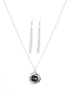 Glistening silver bars swirl around a shiny black bead, creating a colorful pendant below the collar for a seasonal look. Features an adjustable clasp closure.  Sold as one individual necklace. Includes one pair of matching earrings.