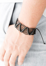 Load image into Gallery viewer, Black twine knots around shiny black cording, creating a netted pattern around the wrist. Features an adjustable sliding knot closure.  Sold as one individual bracelet.  