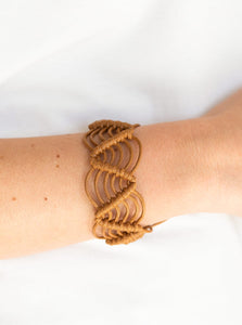Brown twine knots around shiny brown cording, creating a netted pattern around the wrist. Features an adjustable sliding knot closure.  Sold as one individual bracelet.
