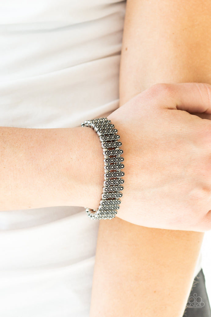 Dainty silver beads and stacked silver frames radiating with sunburst patterns are threaded along stretchy bands around the wrist for a whimsical look.  Sold as one individual bracelet.  