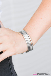 Etched in tactile textures, six shimmery bangles connect to two silver bars, creating a layered cuff. As the cuff slides up and down the wrist, it creates the illusion of a stack of classic bangles.  Sold as one individual bracelet.  Always nickel and lead free.