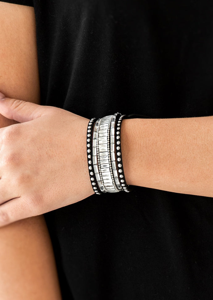 Shiny silver studs, dainty silver ball chains, and edgy white emerald-cut rhinestones race along a spliced black suede band for a rock star look. Features an adjustable snap closure.  Sold as one individual bracelet.