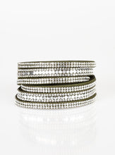 Load image into Gallery viewer, Encrusted in rows of glassy white rhinestones and flat silver studs, three strands of green suede wrap around the wrist for a sassy look. The elongated band allows for a trendy double wrap around the wrist. Features an adjustable snap closure. Sold as one individual bracelet.