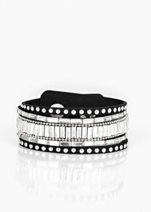 Shiny silver studs, dainty silver ball chains, and edgy white emerald-cut rhinestones race along a spliced black suede band for a rock star look. Features an adjustable snap closure. Sold as one individual bracelet.