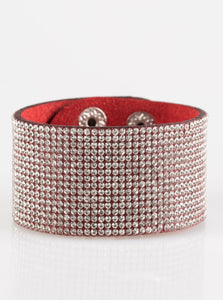 Row after row of glassy white rhinestones are encrusted along a thick red suede band, creating knockout shimmer across the wrist. Features an adjustable snap closure.  Sold as one individual bracelet.