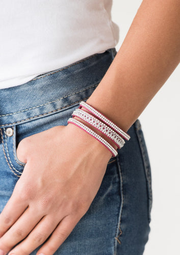 Rows of glassy white rhinestones and a shimmery silver chain are encrusted along vibrant pink suede bands for a sassy look. Features an adjustable snap closure.  Sold as one individual bracelet. 