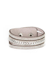 Rows of glassy white rhinestones and a shimmery silver chain are encrusted along gray suede bands for a sassy look. Features an adjustable snap closure.  Sold as one individual bracelet.  Always nickel and lead free.
