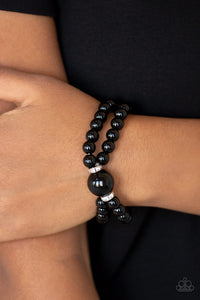 Joined at the center by an over-sized black bead and a pair of white rhinestone encrusted rings, shiny black beads are threaded along stretchy bands around the wrist for a timelessly layered look.  Sold as one individual bracelet.  Always nickel and lead free.