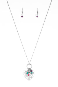 Infused with dainty multicolored pearls and a shimmery silver heart charm, a stenciled silver heart pendant swings from the bottom of a lengthened silver chain for a whimsical look. Features an adjustable clasp closure. Sold as one individual necklace. Includes one pair of matching earrings.