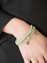 Load image into Gallery viewer, ﻿Dainty green and gray beads are threaded along stretchy elastic bands, creating colorful layers across the wrist. Brushed in an antiqued shimmer, dainty floral charms swing from the wrist for a seasonal finish.  Sold as one set of three bracelets.  
