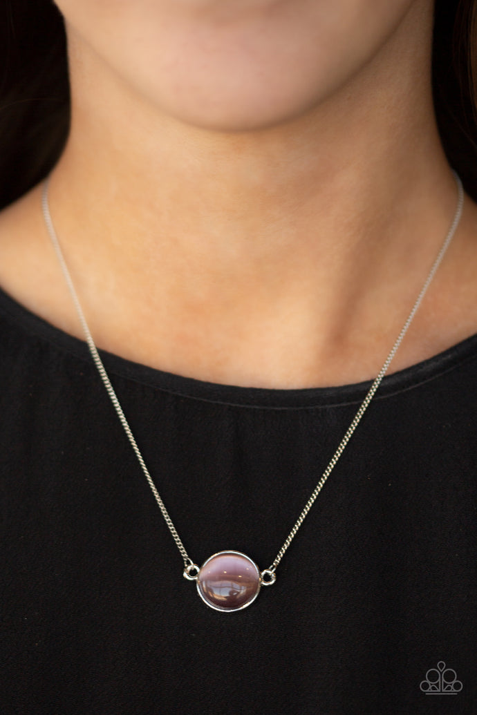 A glassy purple cat's eye stone attaches to a shimmery silver chain, creating a stationary pendant below the collar. Features an adjustable clasp closure.  Sold as one individual necklace. Includes one pair of matching earrings.  Always nickel and lead free.