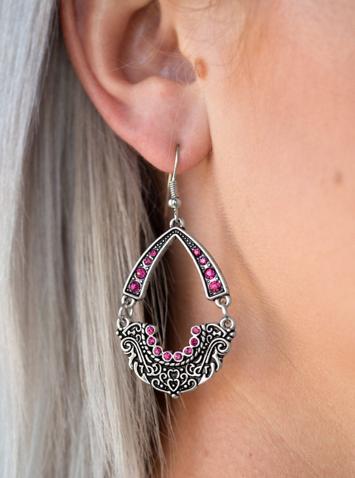 Encrusted in dazzling pink rhinestones, an arcing silver frame links with an ornate silver frame radiating with filigree filled details for a refined look. Earring attaches to a standard fishhook fitting.  Sold as one pair of earrings.  