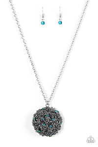 Leafy silver rosebuds coalesce into a dramatic 3-dimensional pendant. Blue rhinestones are sprinkled across the front of the vintage inspired pendant for a regal finish. Features an adjustable clasp closure. Sold as one individual necklace. Includes one pair of matching earrings.
