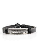 Load image into Gallery viewer, Embossed in an edgy geometric pattern, a silver plate is knotted in place along the front of a black leather band for a rugged look. Features an adjustable sliding knot closure.  Sold as one individual bracelet.