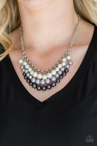Rows of white, silver, and gunmetal pearls cascade below the collar, creating a glamorous fringe. Features an adjustable clasp closure.  Sold as one individual necklace. Includes one pair of matching earrings.  Always nickel and lead free.