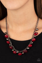 Load image into Gallery viewer, Featuring cloudy and glassy finishes, faceted red crystal-like beads swing from the bottom of a glistening gunmetal chain. Faceted gunmetal beads join the fiery beading, creating a flirtatious fringe below the collar. Features an adjustable clasp closure.  Sold as one individual necklace. Includes one pair of matching earrings.  Always nickel and lead free.
