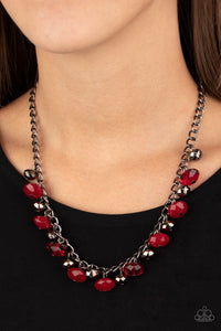 Featuring cloudy and glassy finishes, faceted red crystal-like beads swing from the bottom of a glistening gunmetal chain. Faceted gunmetal beads join the fiery beading, creating a flirtatious fringe below the collar. Features an adjustable clasp closure.  Sold as one individual necklace. Includes one pair of matching earrings.  Always nickel and lead free.