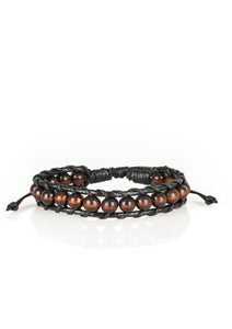 Earthy wooden beads are threaded along black shiny cording around the wrist for a seasonal look. Features an adjustable sliding knot closure.  Sold as one individual bracelet.