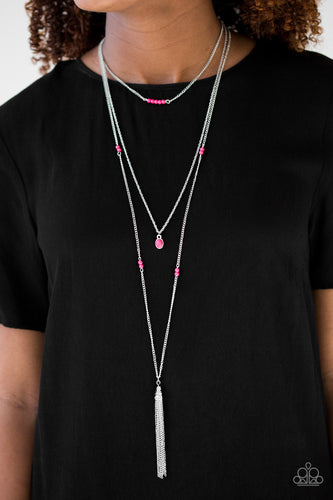 Threaded along a dainty rod, a row of vivacious pink stones are suspended horizontally above a dainty pink stone pendant. A shimmery silver tassel swings from the lowermost chain, adding a whimsical finish to the seasonal palette. Features an adjustable clasp closure.  Sold as one individual necklace. Includes one pair of matching earrings.