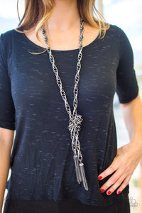 A single strand of spiraling, interlocking links with light-catching texture is anchored by two tassels of chain that add dramatic length to the piece. Undeniably the most versatile piece in Paparazzi's history, the scarf necklace features FIVE different ways to accessorize: Open Layer, Loop, Traditional Wrap, Double Knot, and Nautical Knot.  Sold as one individual necklace. Includes one pair of matching earrings.