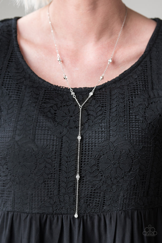 Sections of shiny silver, polished white, and glassy beads trickle along a shimmery silver chain along the chest for a flirtatious look. Features an adjustable clasp closure.  Sold as one individual necklace. Includes one pair of matching earrings.  Always nickel and lead free. 