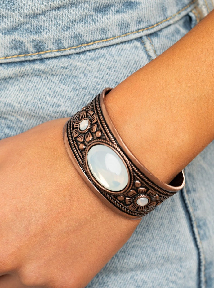 Embossed in whimsical floral and desert inspired details, a thick copper cuff is dotted in opalescent beads for an ethereal look around the wrist.  Sold as one individual bracelet.  Always nickel and lead free.