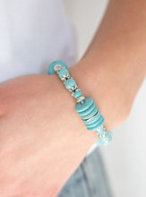 Load image into Gallery viewer, Featuring glistening silver accents, refreshing disc-shaped and round turquoise stone beads are threaded along a stretchy band for a seasonal look.  Sold as one individual bracelet. 